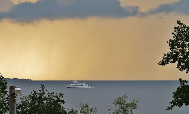Chief cruises placid lake ahead of rain. North Bay, Ontario Canada