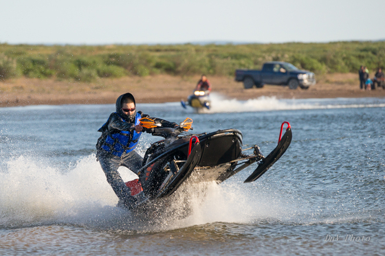 Snowmobiles Skipping Water 112