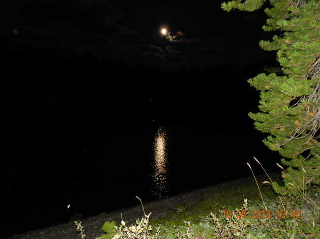 Reflection of full moon on Lower Kananaskis Lake Kananaskis, Alberta Canada