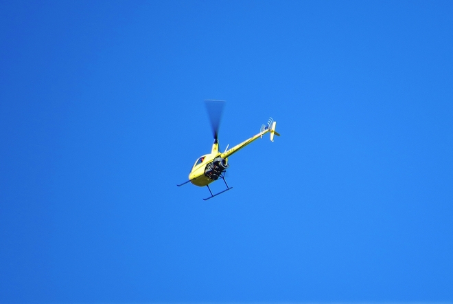 Unusual yellow helicopter with purple legs. North Bay, Ontario Canada