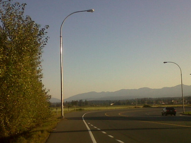 Sun setting on highway. Courtenay, British Columbia Canada