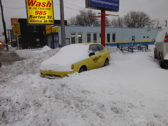 Snow covered car Hamilton, Ontario Canada