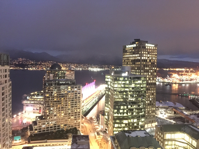 Dark clouds in the mountains from downtown. Vancouver, British Columbia, CA