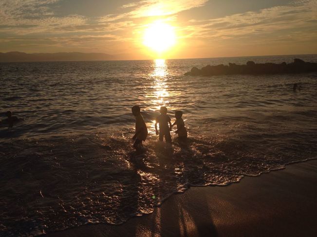Kids play on the sunset beach Puerto Vallarta, JAL