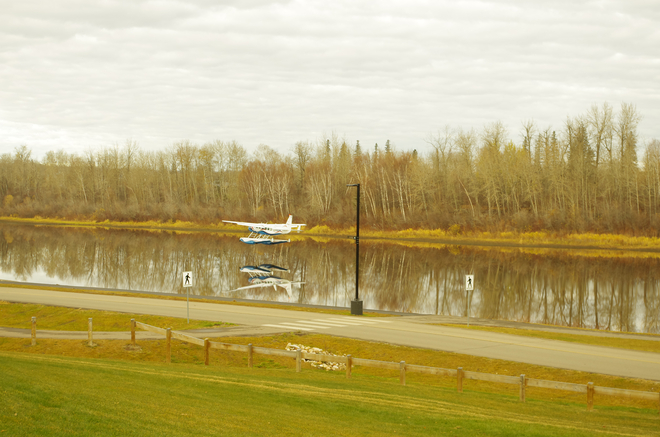 Reflections of a float plane on the Snye. Fort McMurray, Alberta, CA