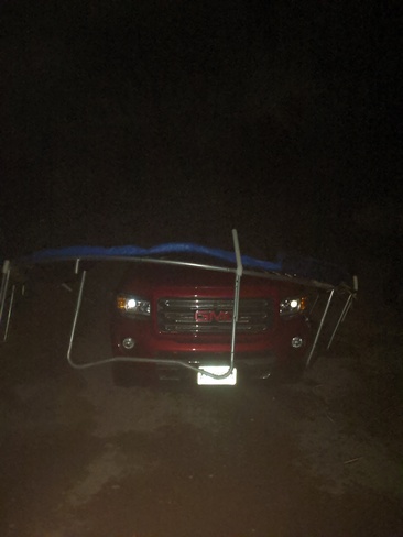 truck taking cover from storm under trampoline Kingston, ON