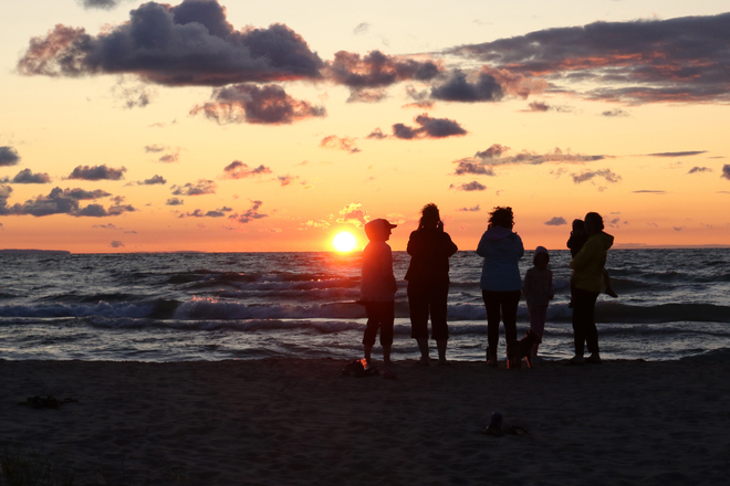 Family watching the Sunset at New Wasaga Beach Wasaga Beach, ON